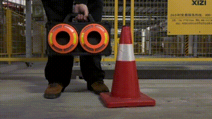 Traffic cone lamp specification sheet beside a sample unit showing magnet, battery, and housing details for B2B buyers